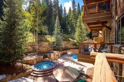 a patio with a hot tub on a deck at Timbers 3064 : 2 in Keystone