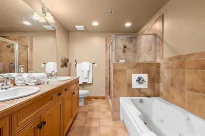a bathroom with two sinks and a tub and a toilet at Timbers 3064 : 2 in Keystone