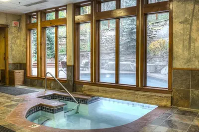 a hot tub in a room with windows at Timbers 3064 : 2 in Keystone