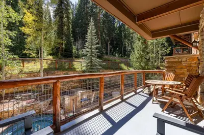 a deck with a table and chairs on a porch at Timbers 3064 : 2 in Keystone