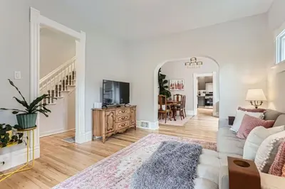 a living room with a couch and a tv at Updated Victorian Home in SoBo in Denver