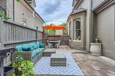 a patio with a couch and a table with an umbrella at Updated Victorian Home in SoBo in Denver