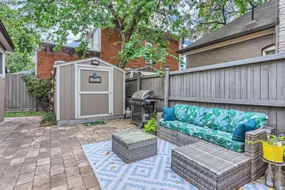 a backyard with a couch and a grill and a fence at Updated Victorian Home in SoBo in Denver