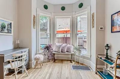 a living room with a window seat and a desk at Updated Victorian Home in SoBo in Denver