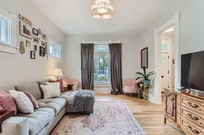 a living room with a couch and a tv at Updated Victorian Home in SoBo in Denver