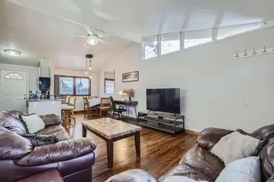 a living room with two leather couches and a table at Vaulted Ceilings, Natural Light Apt near Olde Town in Arvada