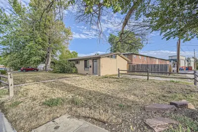 a small house in a yard with a fence at Vaulted Ceilings, Natural Light Apt near Olde Town in Arvada
