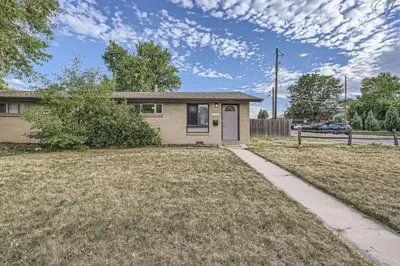 a small house with a yard and a driveway at Vaulted Ceilings, Natural Light Apt near Olde Town in Arvada