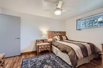 a bedroom with a bed and a ceiling fan at Vaulted Ceilings, Natural Light Apt near Olde Town in Arvada