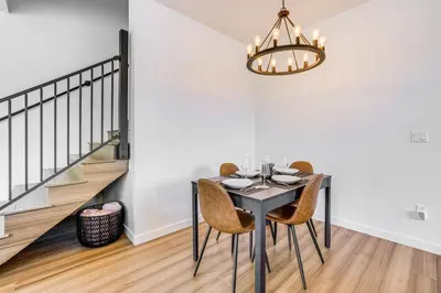 a dining room with a table with chairs and a chandelier at Mtn-View Slopeside Chalet in Granby Ranch! in Granby