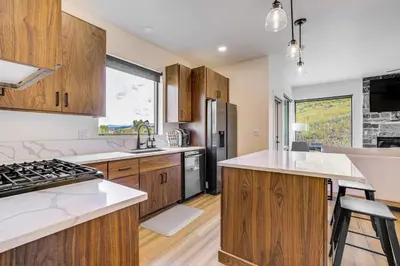 a kitchen with wooden cabinets and white counter tops at Mtn-View Slopeside Chalet in Granby Ranch! in Granby
