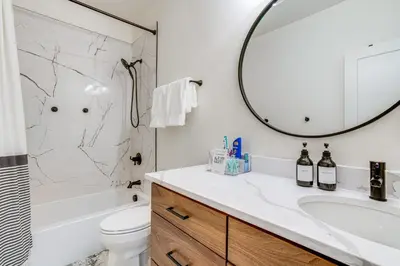 a bathroom with a sink and a toilet and a mirror at Mtn-View Slopeside Chalet in Granby Ranch! in Granby