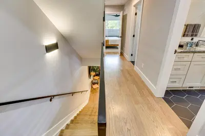 a hallway of a home with white walls and wooden floors at Hot Tub and Mtn-View Rooftop Deck Golden Home in Golden