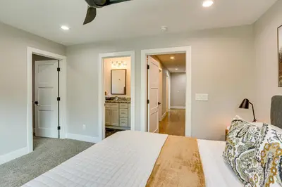 a bedroom with a bed and a bathroom at Hot Tub and Mtn-View Rooftop Deck Golden Home in Golden