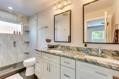 a bathroom with a sink and a toilet and a mirror at Hot Tub and Mtn-View Rooftop Deck Golden Home in Golden