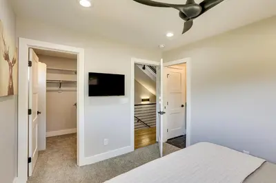 a bedroom with a bed and a ceiling fan at Hot Tub and Mtn-View Rooftop Deck Golden Home in Golden
