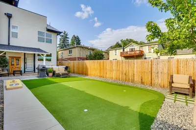 a backyard with a artificial lawn and a wooden fence at Hot Tub and Mtn-View Rooftop Deck Golden Home in Golden