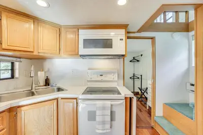 a kitchen with a stove and a microwave at 4 Mi to Ski Resort Pet-Friendly Breck Cabin in Breckenridge