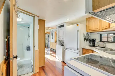 a kitchen with white appliances and wooden cabinets at 4 Mi to Ski Resort Pet-Friendly Breck Cabin in Breckenridge