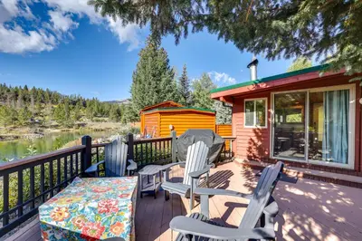 a cabin with chairs and a table on a deck at 4 Mi to Ski Resort Pet-Friendly Breck Cabin in Breckenridge