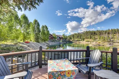a deck with two chairs and a table with a view of a lake at 4 Mi to Ski Resort Pet-Friendly Breck Cabin in Breckenridge