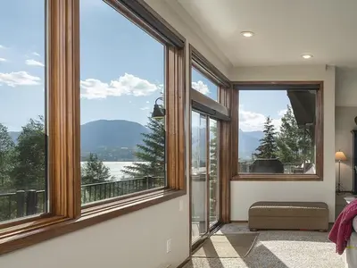 a room with large windows with a view of the water at Luxury By The Lake in Dillon