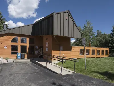 a large wooden building with a lot of windows at Luxury By The Lake in Dillon
