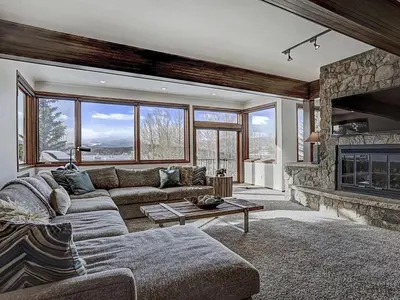 a living room with a couch and a fireplace at Luxury By The Lake in Dillon