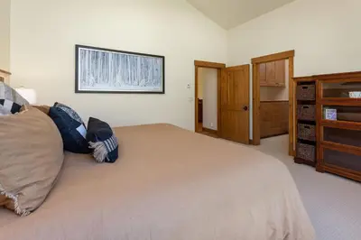 a bedroom with a large bed and a dresser at 43 Thackwell condo in Keystone