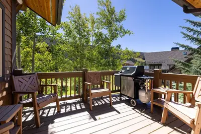 a grill on the deck of a house at 43 Thackwell condo in Keystone