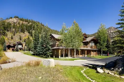 a house in the mountains with a driveway at 43 Thackwell condo in Keystone