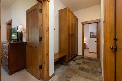a hallway with wooden cabinets and a desk in a room at 43 Thackwell condo in Keystone