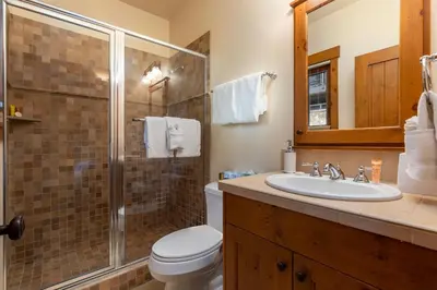 a bathroom with a shower and a toilet and a sink at 43 Thackwell condo in Keystone