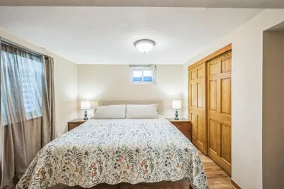 a bedroom with a bed and a wooden door at Bright & Cozy House Centennial Littleton 4 Bed 3 Bath in Centennial