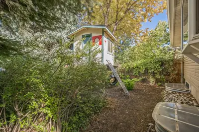 a tiny house in the woods next to a house at Bright & Cozy House Centennial Littleton 4 Bed 3 Bath in Centennial
