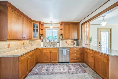 a kitchen with wooden cabinets and a large island at Bright & Cozy House Centennial Littleton 3 Bed 3 Bath in Centennial