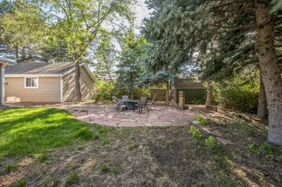 a patio with a table and chairs in a yard at Bright & Cozy House Centennial Littleton 3 Bed 3 Bath in Centennial