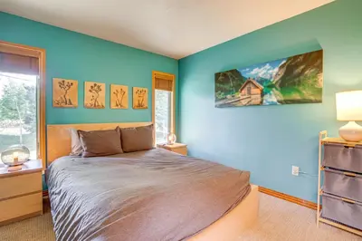 a bedroom with a bed with blue walls and a window at Mtn-View Frisco Home Near Skiing and Hiking! in Frisco