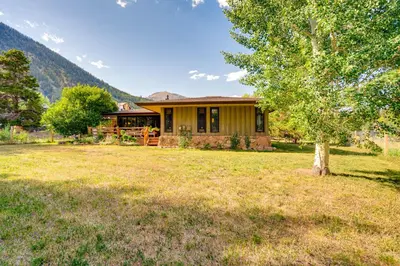 a house with a tree in front of a yard at Mtn-View Frisco Home Near Skiing and Hiking! in Frisco
