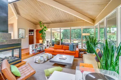 a living room with an orange couch and a fireplace at Mtn-View Frisco Home Near Skiing and Hiking! in Frisco