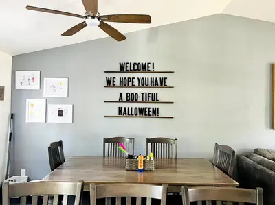 a dining room table with chairs and a ceiling fan at Hot Tub Steam Shower Gym in Charming Family Home! in Lafayette