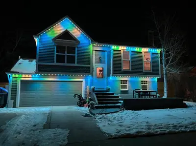 a house with blue and green lights on it at Hot Tub Steam Shower Gym in Charming Family Home! in Lafayette