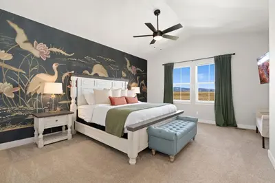 a bedroom with a bed with a large painting on the wall at Scenic Mountain Retreat Golf, Pickleball, Relax in Loveland
