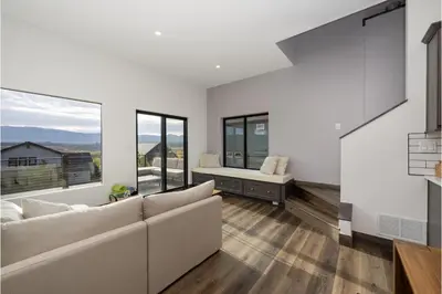 a living room with a couch and large windows at Scenic Perch home in Tabernash