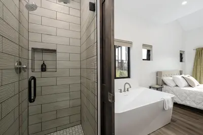 a bathroom with a tub and a shower and a sink at Scenic Perch home in Tabernash