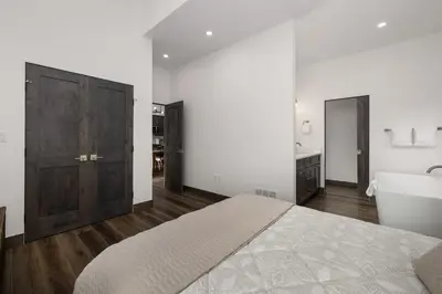 a bedroom with a bed and a tub and a sink at Scenic Perch home in Tabernash
