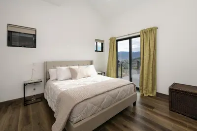 a bedroom with a bed and a large window at Scenic Perch home in Tabernash