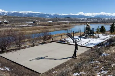 an empty concrete pad with a statue in front of a river at Scenic Perch home in Tabernash
