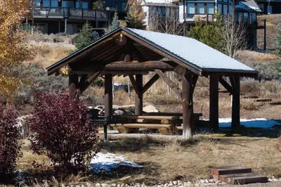 a wooden gazebo in the middle of a field at Scenic Perch home in Tabernash