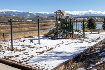 a playground with a slide in the snow at Scenic Perch home in Tabernash